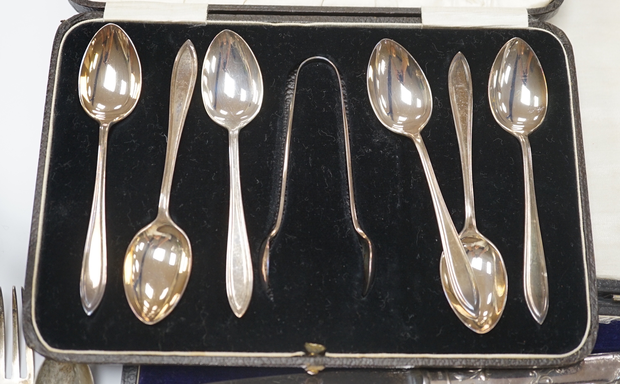 Two cased sets of silver flatware including teaspoons with tongs, nine assorted items of silver flatware including an 18th century base mark sauce ladle and a pair of later tablespoons and a small silver christening mug.